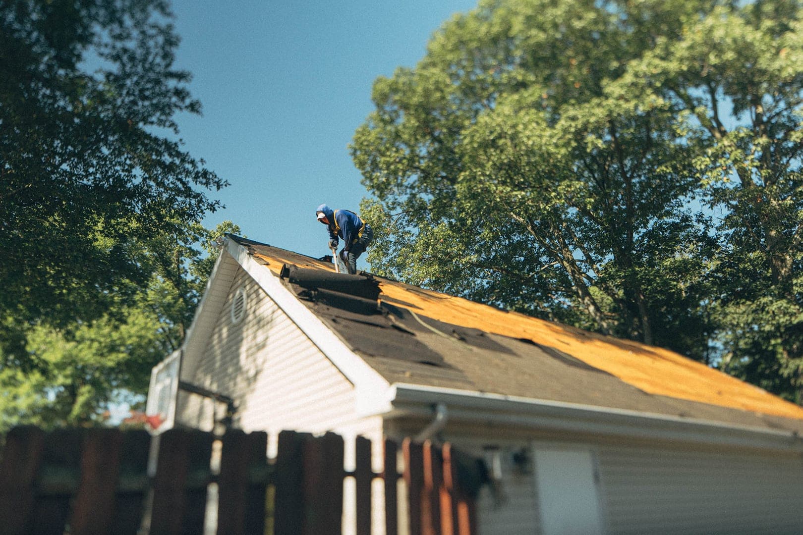 Roofing crew installing a shingle roof