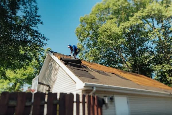 Roofing crew installing a shingle roof