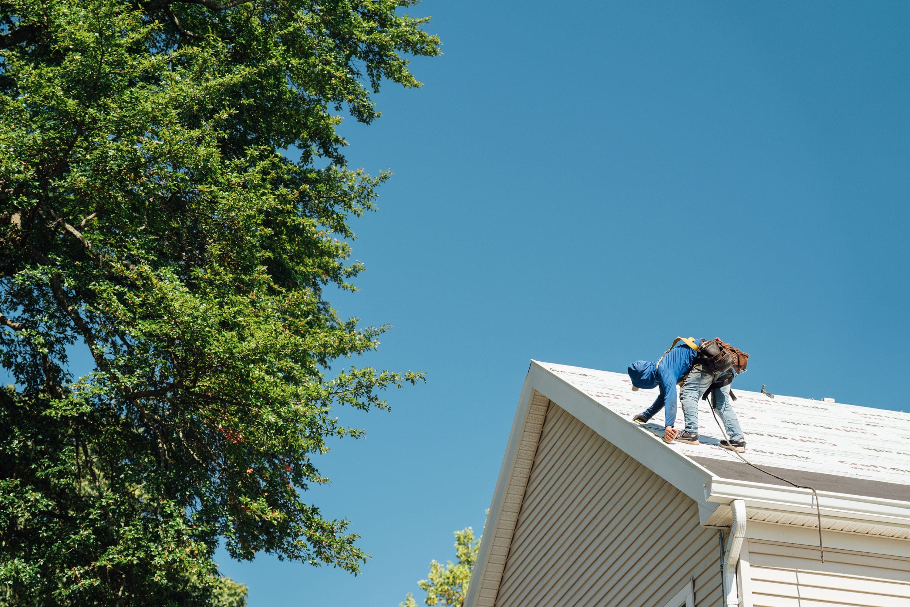 Roofer working on a residential roof during installation